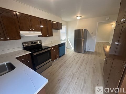 A kitchen with wooden cabinets and stainless steel appliances.