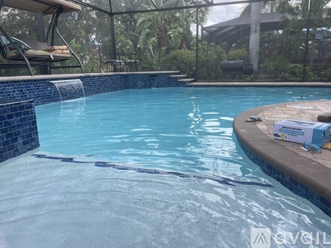 A swimming pool with a blue tiled edge and a brown tiled edge.