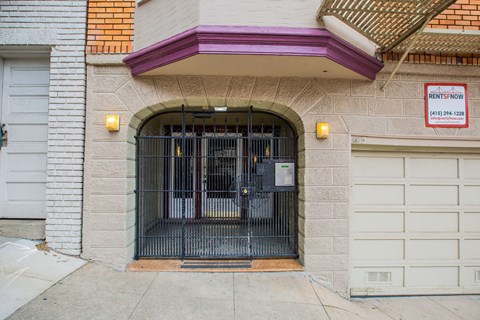A building with a purple awning and a sign that says "RENTSNOW" on it.