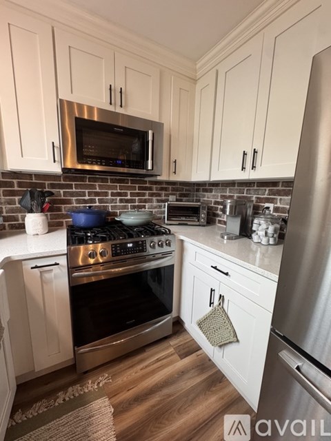 A kitchen with a stove top oven and a microwave above it.