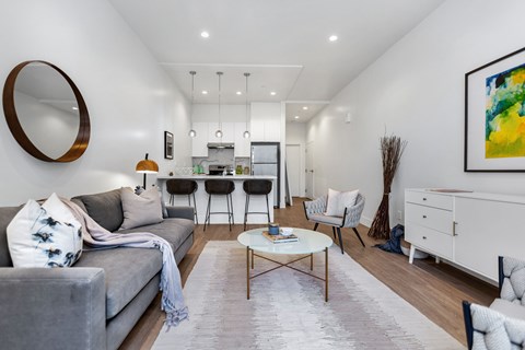 A modern living room with a grey sofa and a coffee table.