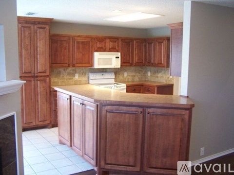 A kitchen with wooden cabinets and a countertop.