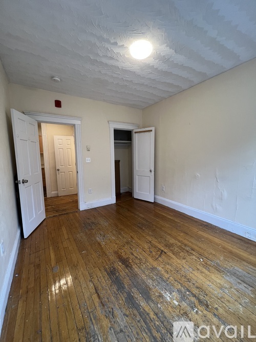 A room with wooden floors and white walls.