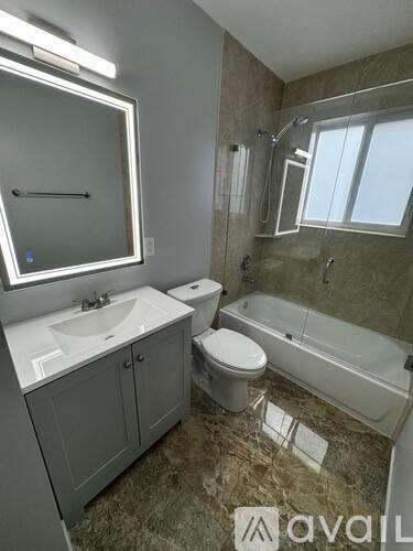 A bathroom with a sink, toilet, and bathtub.