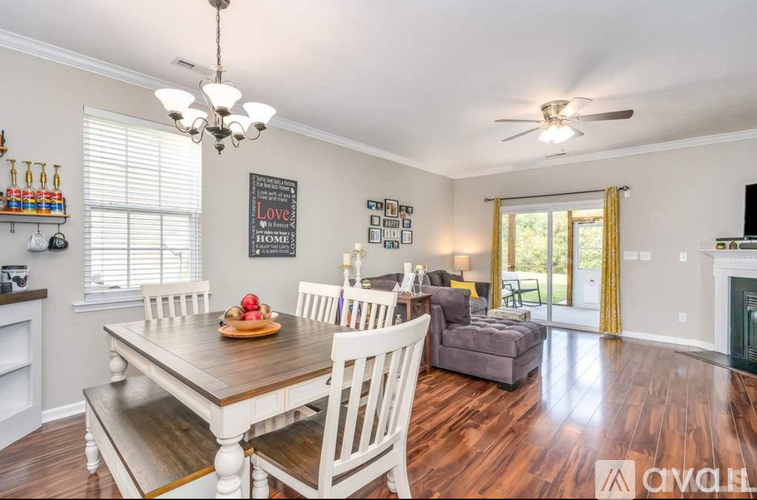 A dining room with a wooden table and chairs.
