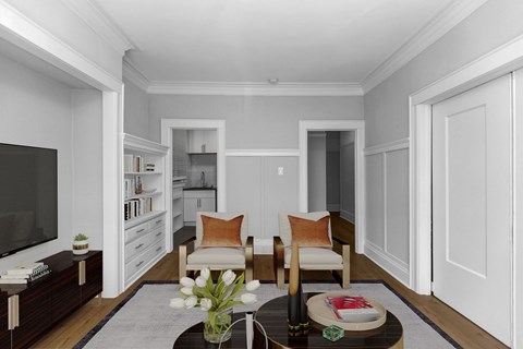 A living room with a sofa, armchairs, and a coffee table.