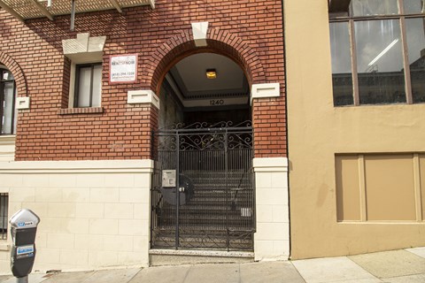 A black gate with a sign above it that says "No Parking".