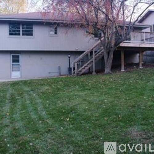 A house with a tree in front of it.