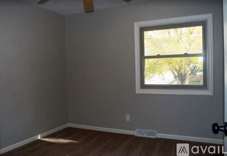 A room with a window and a door.
