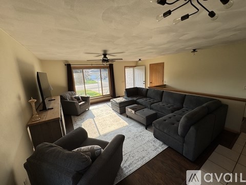 A living room with a grey couch and a television.