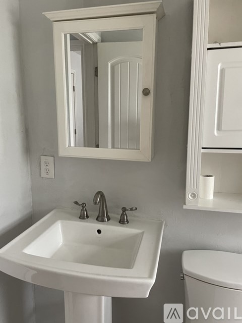 A kitchen with a stove and microwave above it.