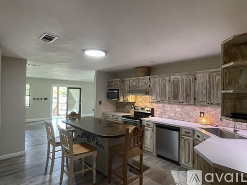 A kitchen with wooden cabinets and a center island.