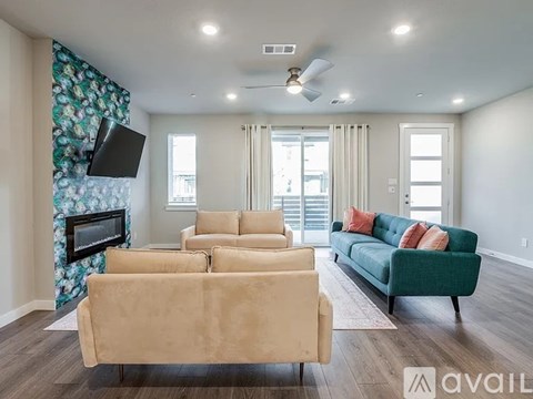 A living room with a beige couch and a green couch.