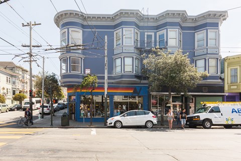 A blue building with a rainbow painted on the front.