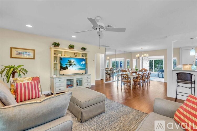 A dining room with a wooden table and chairs.