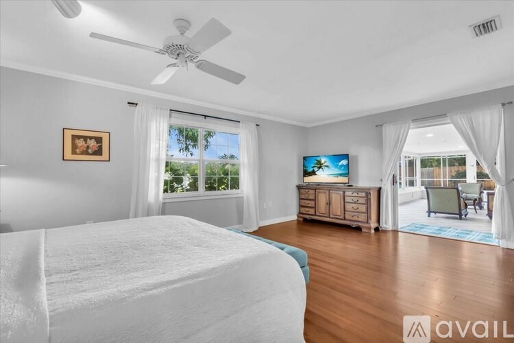 A bedroom with a large bed and a television.