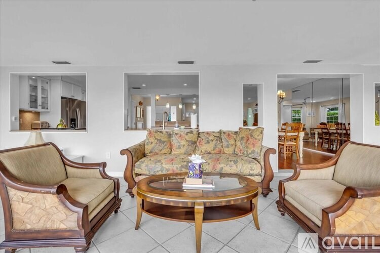 A living room with a sofa, armchair, and coffee table.