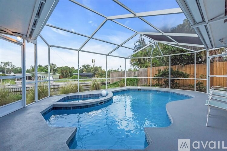 A pool inside a house with a glass ceiling.