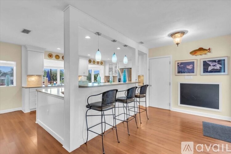 A living room with a bar area and a fireplace.