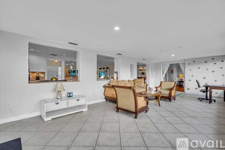 A living room with a white couch and a coffee table.