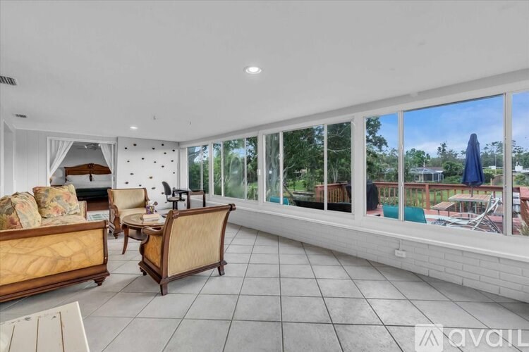 A sunny day at the beach with a blue umbrella.