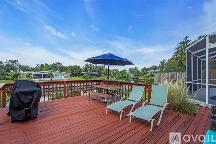 A deck with chairs and an umbrella is available for rent.