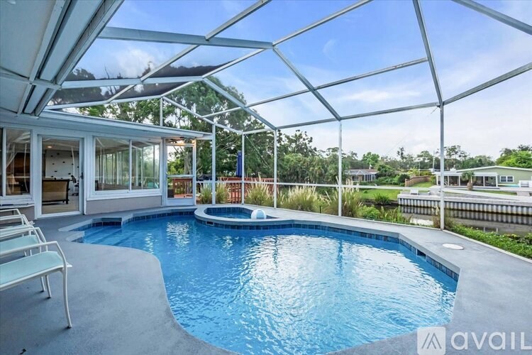 A pool inside a house with a glass ceiling.