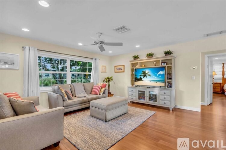 A backyard with a wooden deck and a small pond.