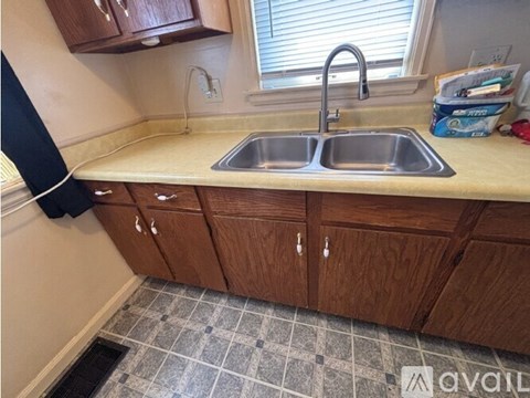 A kitchen with a sink and cabinets.