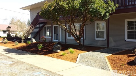 A house with a tree in front of it.