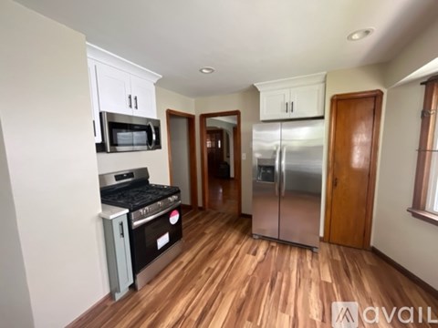 A kitchen with a stainless steel refrigerator and microwave.