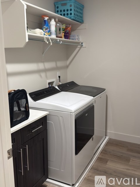 A small kitchen with a white dishwasher and black microwave.
