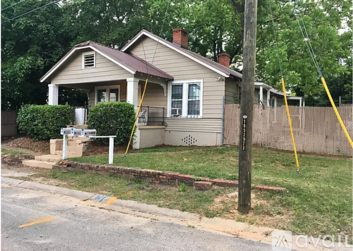 A house with a brown roof and a white fence.