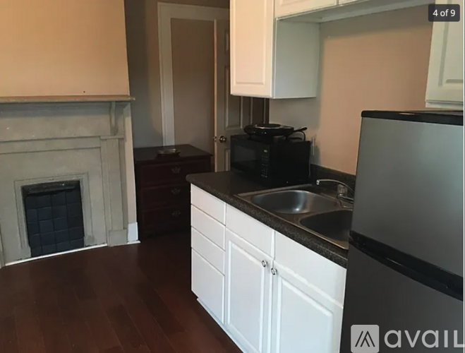 A kitchen with white cabinets and a black stove top oven.