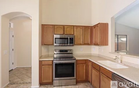 A kitchen with wooden cabinets and stainless steel appliances.