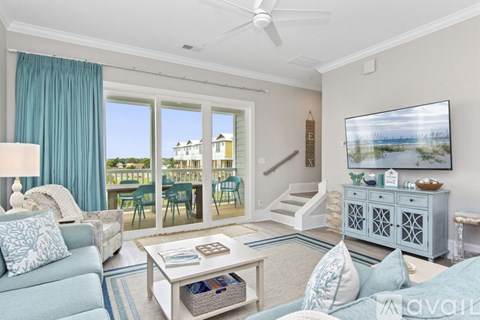 A living room with a blue couch and a white coffee table.