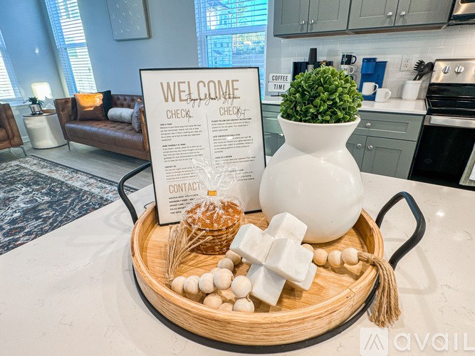 A welcome sign is on a table with a tray of bread, sugar cubes, and a plant.