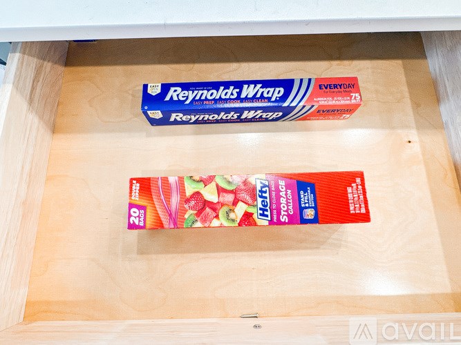 A box of fruit-flavored lifesavers sits in a drawer under a box of Reynolds Wrap.