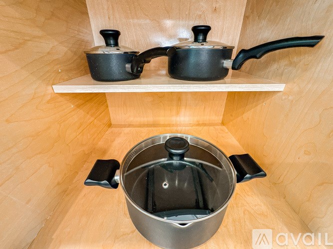 A kitchen shelf with a pot and a kettle on it.