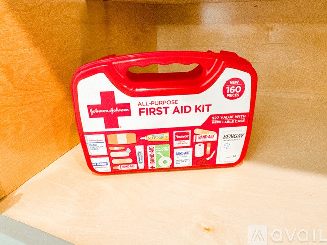 A red first aid kit with a white cross logo on it.