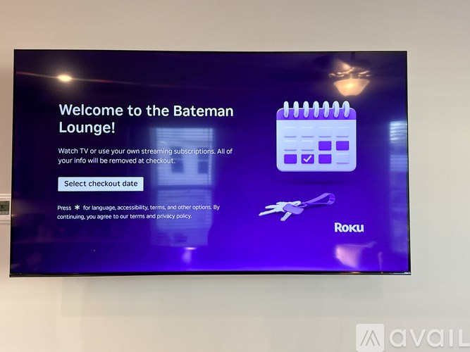 A digital screen displays a welcome message for the Bateman Lounge with a calendar icon and a Roku logo.