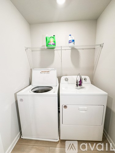 A small bathroom with a toilet and a washing machine.