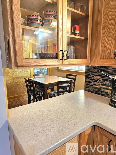 A kitchen with wooden cabinets and a marble countertop.