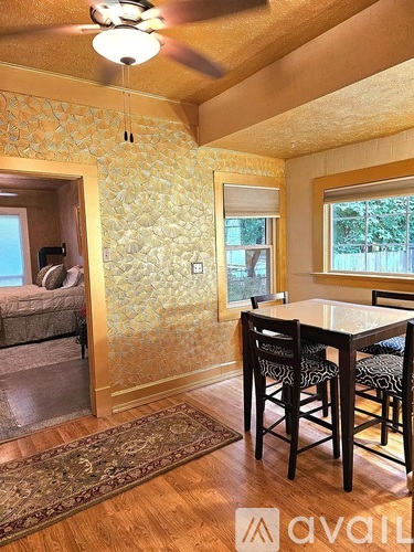 A dining room with a table and chairs.
