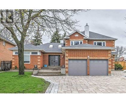 A brick house with a grey roof and a grey garage door.