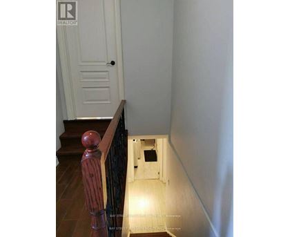 A hallway with a door at the end.