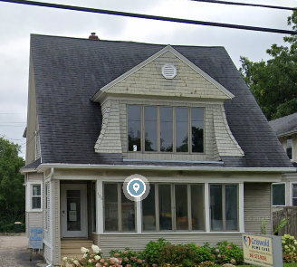 A house with a sign in front of it.