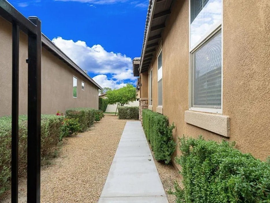 A pathway leads between two rows of houses.