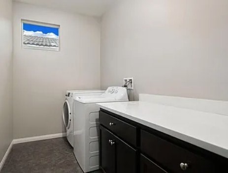 A laundry room with a washer and dryer.