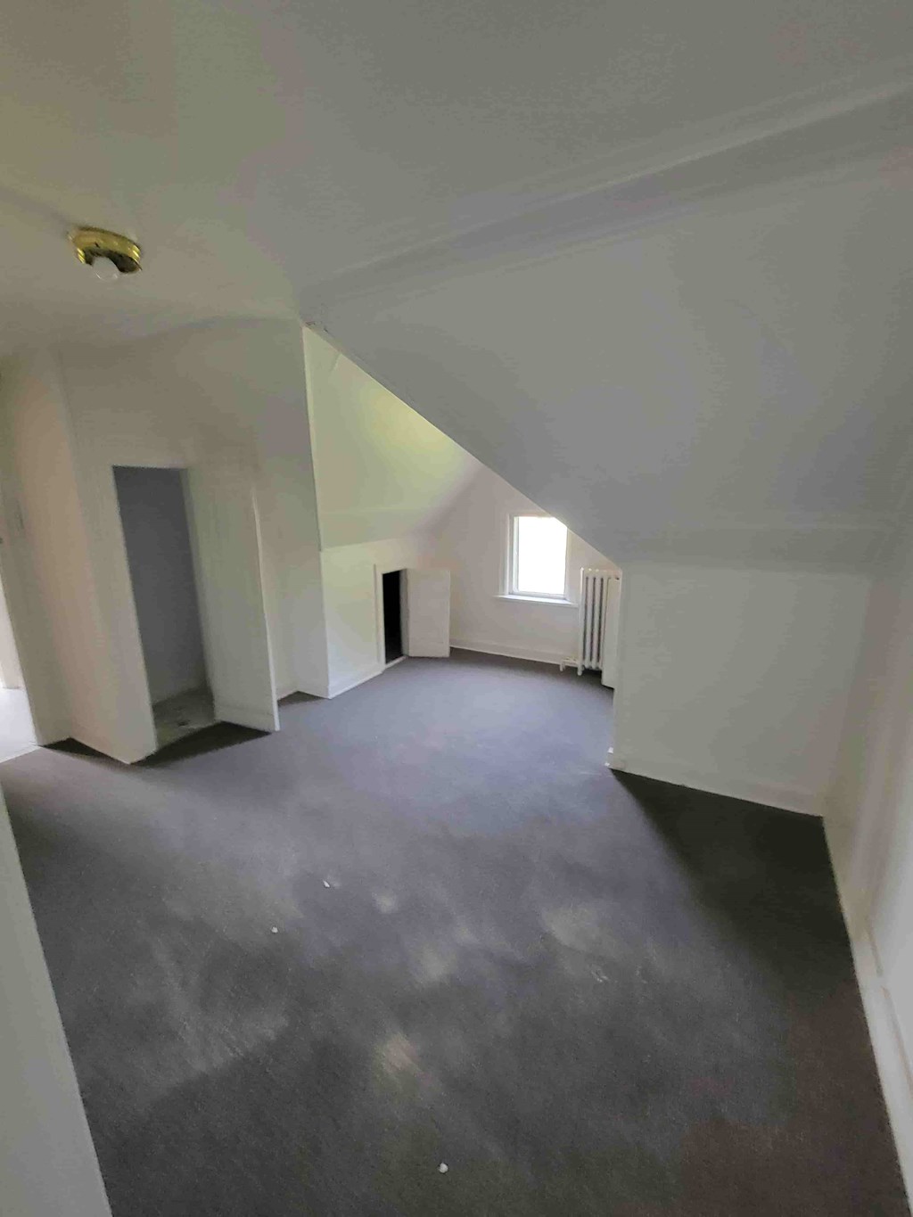 A room with a grey floor and white walls.